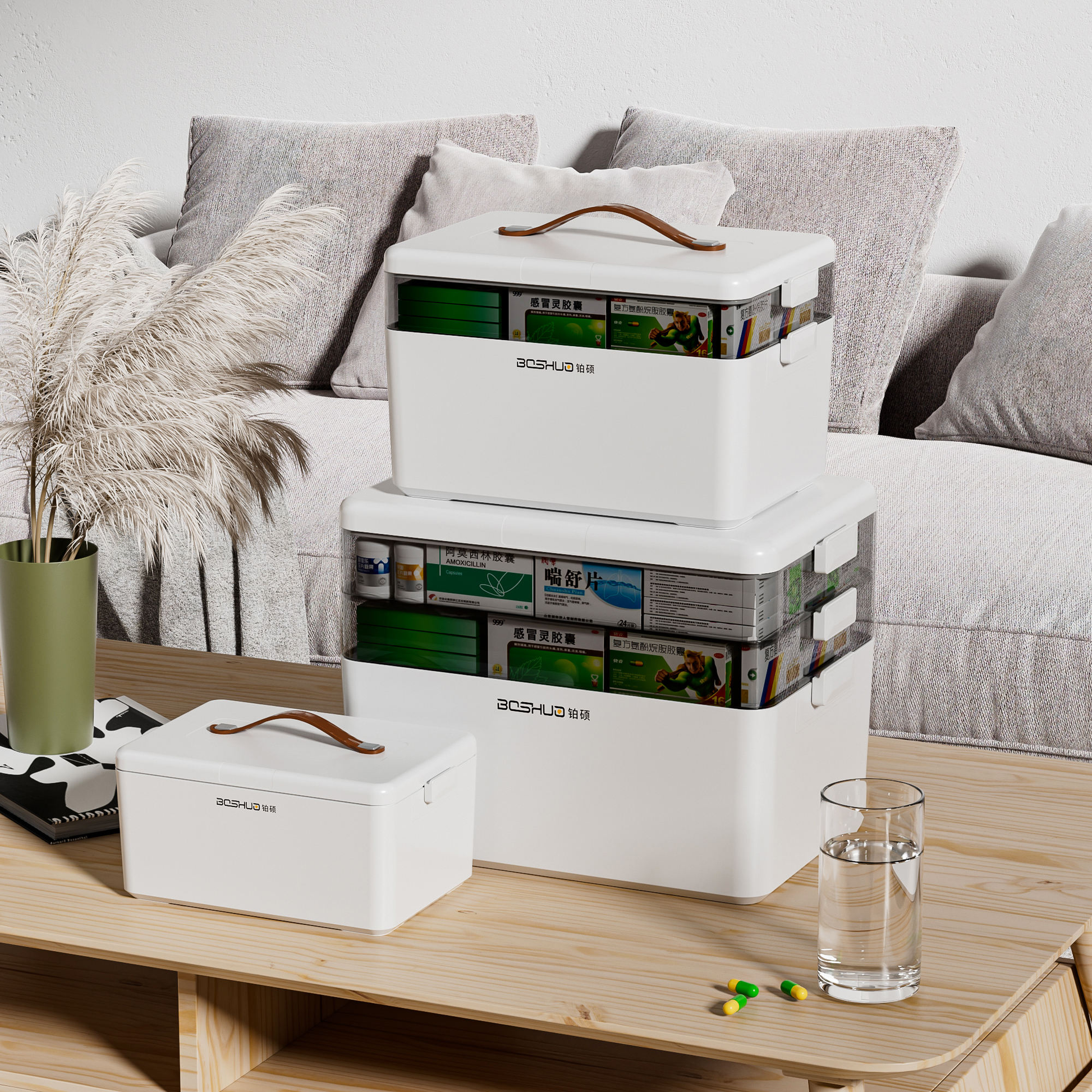 White plastic first aid storage box, lidded compartments and carry handle, stacked view