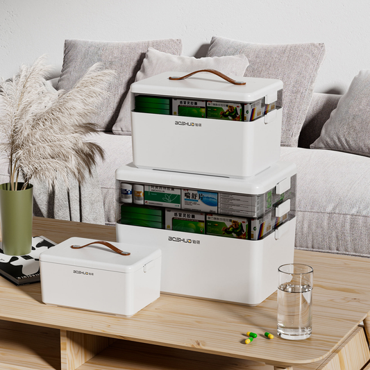 White plastic first aid storage box, lidded compartments and carry handle, stacked view