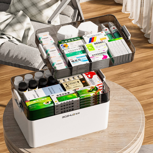 White plastic first aid storage box open with medicine packets and bottles inside